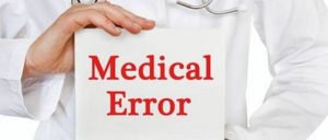 Person holding sign saying Medical Error