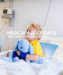 Little boy on hospital bed holding blue toy elephant