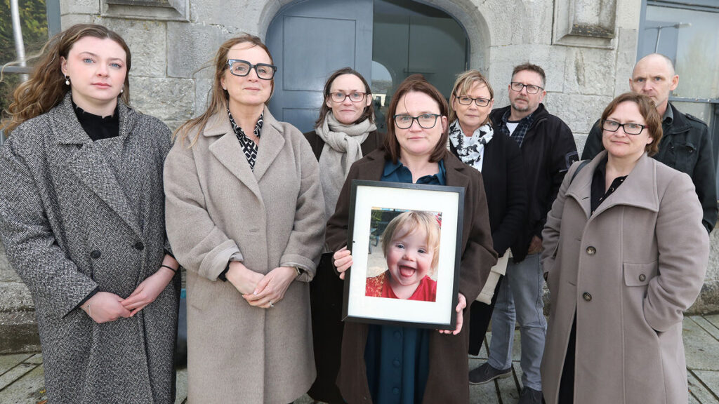 Paula Coote holding a photo of her daughter Nancy Coote with Aoife Bromley, Niamh Ní Mhurchú, Callan Tansey Solicitors, and Aileen Coote, Stephanie and Paddy Garrihy, and John and Gillian Coote, at the Coroners Court in Kilmallock. Picture: Brendan Gleeson