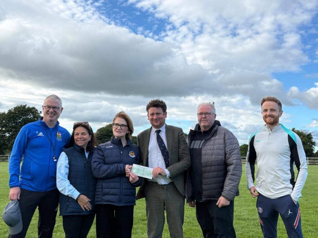 David O'Malley of Callan Tansey Solicitors presents a sponsorship cheque to the Knockmore GAA chairperson Liz McHale and management of the  club.